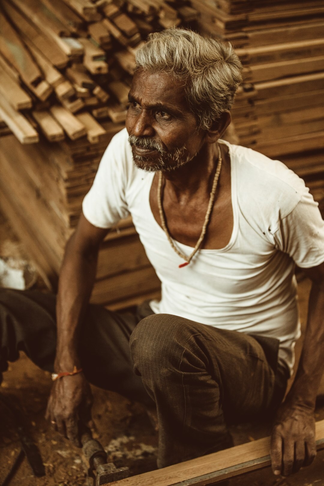 Elderly Danish craftsman working in a wood workshop